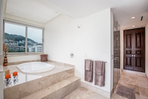 Bathtub, jetted bath, hair dryer, towels