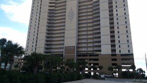 Un grand hôtel avec de nombreux étages, des balcons et un parking souterrain.