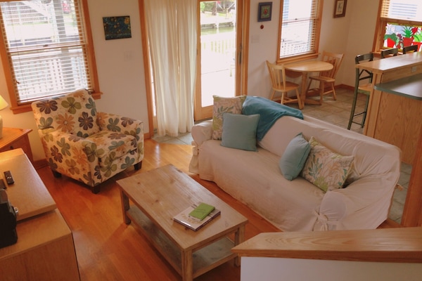 Downstairs living room with sliding door leading to canal side.