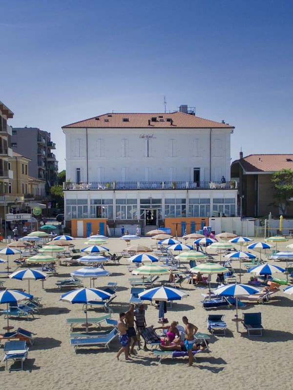 On the beach, white sand, beach umbrellas, beach towels