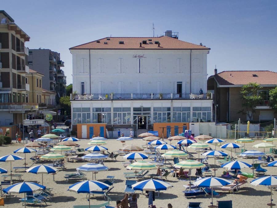 On the beach, white sand, beach umbrellas, beach towels
