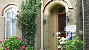 A building with a sign reading "KENBURY" and a door with a red frame. - The Kenbury (Shanklin)