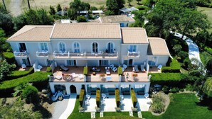A large, multi-story building with multiple balconies, outdoor seating areas, and a well-maintained garden. - Il Borghetto Resort & Spa (Tropea)