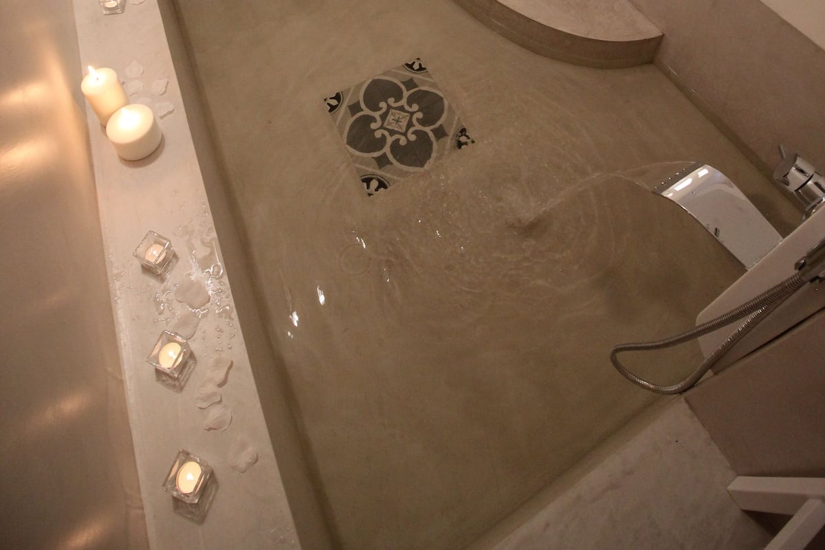 A modern bathroom with a freestanding bathtub, a shower, and a large mirror.