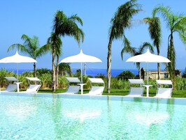Una piscina al aire libre de temporada, sombrillas