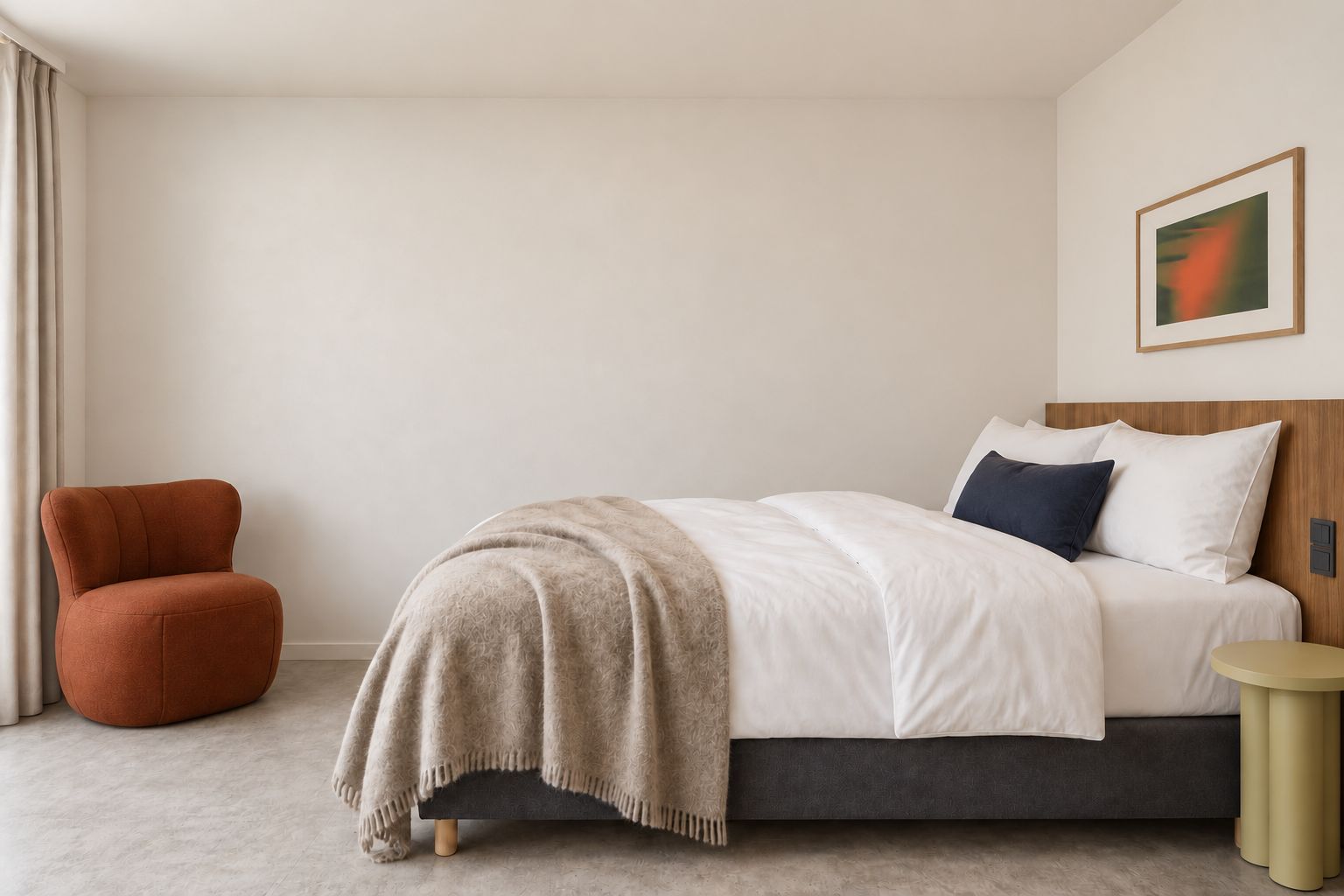 A modern bedroom with a bed, a chair, and a bedside table.