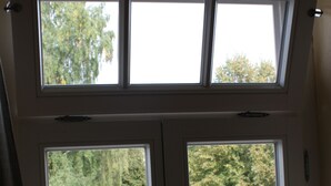 A double door with two windows, each with a view of a green landscape and trees. - Landhaus Hui Wäller (Greifenstein)