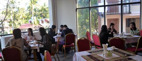 A restaurant with tables and chairs arranged for dining.