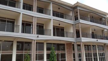 A multi-story hotel with balconies, large windows, and a modern architectural design.