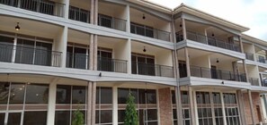 A multi-story hotel with balconies, large windows, and a modern architectural design.