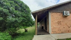 Un edificio con fachada de ladrillo y un umbral abierto que da a un espacio interior.
