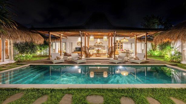 A poolside lounge with a thatched roof, seating, and a view of the pool. - Central Oberoi, Seminyak - Newly Refurbished Villa A (Seminyak)