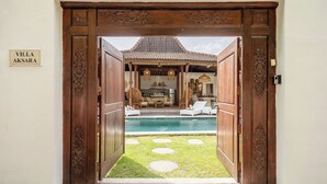 A villa entrance with a pool, outdoor seating, and a sign reading "VILLA AKSARA". - Central Oberoi, Seminyak - Newly Refurbished Villa A (Seminyak)