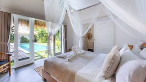 A bedroom with a large bed, white bedding, and a canopy. There is a pool visible through the glass door. - Central Oberoi, Seminyak - Newly Refurbished Villa A (Seminyak)