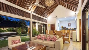 A spacious living area with a sofa set, a coffee table, and a dining area with chairs and a table. - Villa Tigamangga Central Seminyak Oberoi 10mn walk (Seminyak)