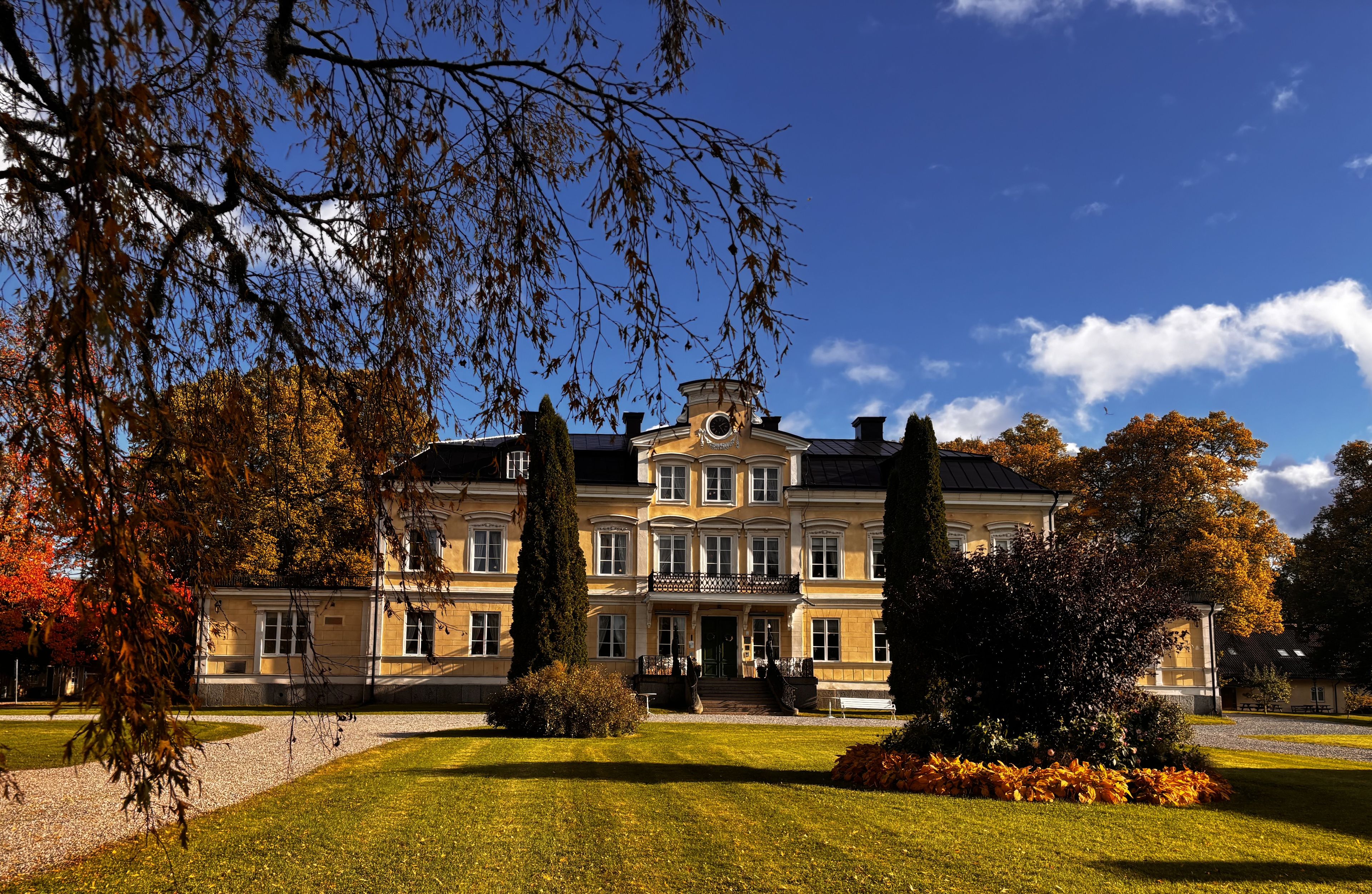 A large, classical building with a symmetrical facade, multiple windows, and a central entrance.