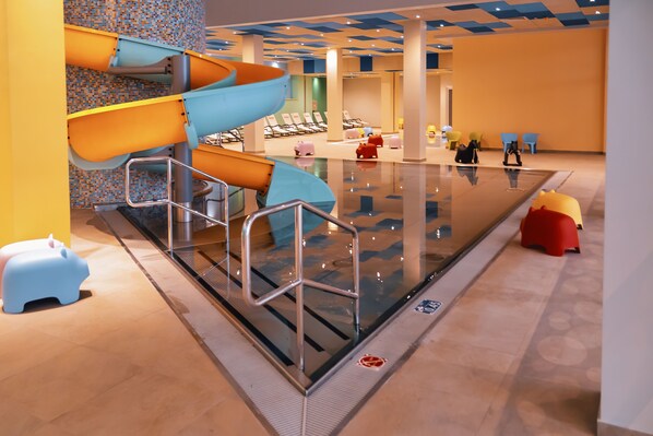 A swimming pool area with a children's play area, including slides and animal-shaped seats. - Etno Naselje Vrdnička Kula (Vrdnik)