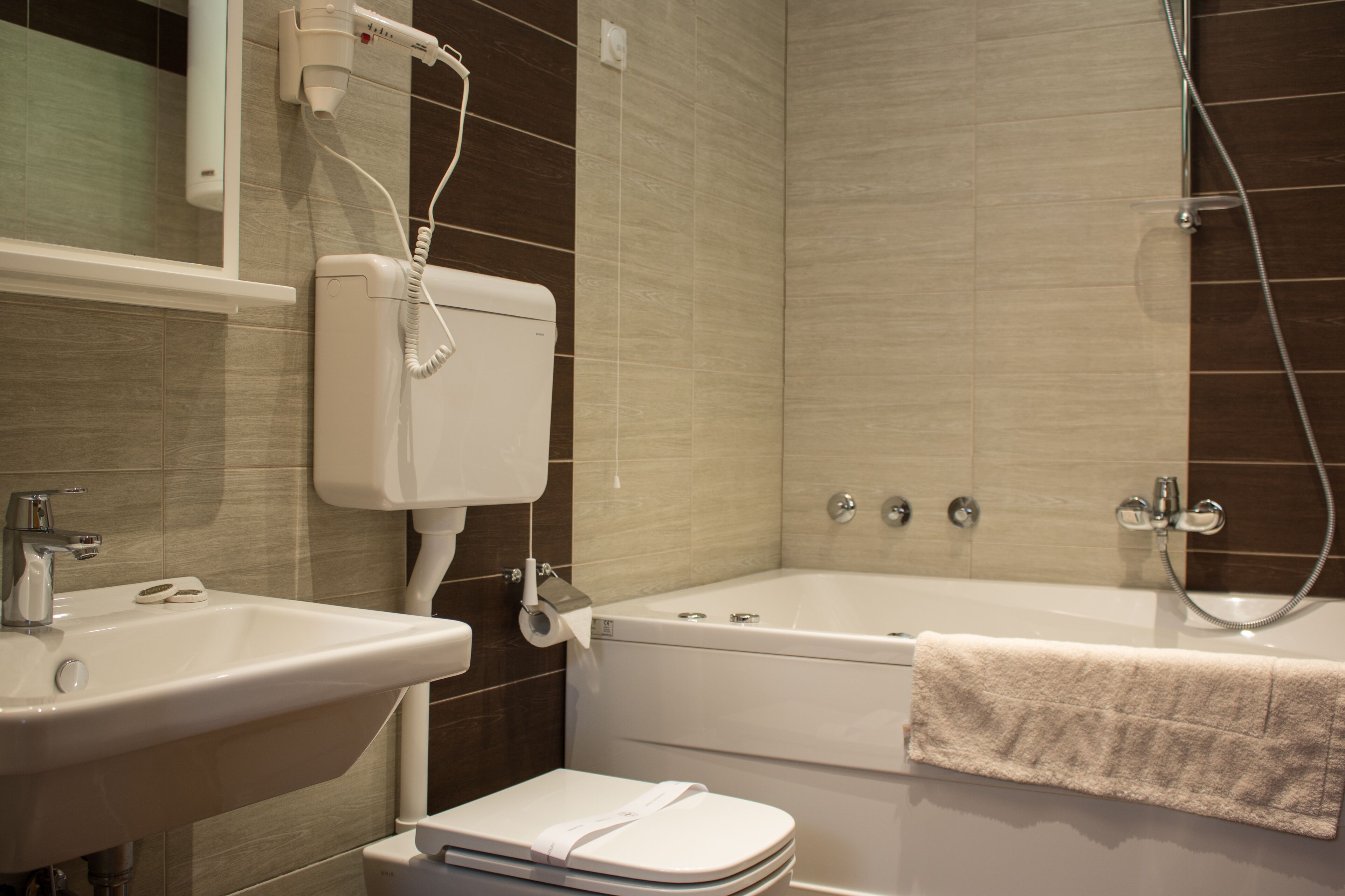 A bathroom with a sink, toilet, and bathtub.