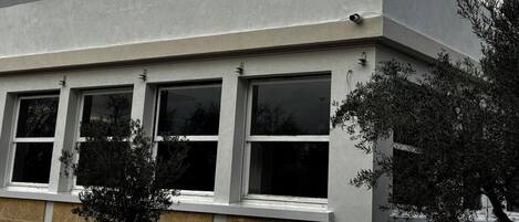 A building with a flat roof, multiple windows, and a weather vane.
