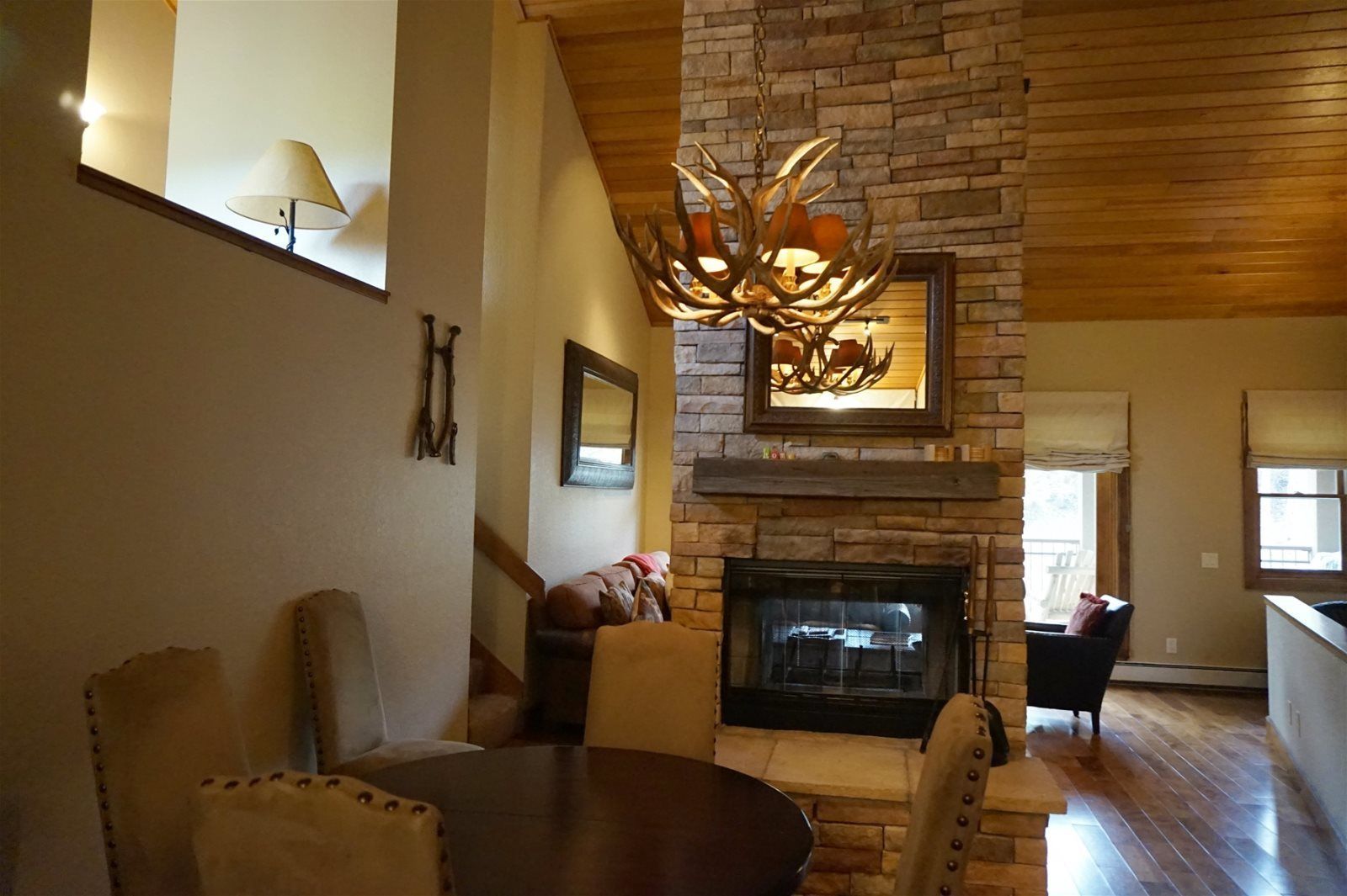A cozy living room with a fireplace, a dining table, and comfortable seating.