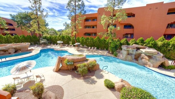 A hotel with a swimming pool, outdoor seating, and a mountainous backdrop. - Summer tenant special, 1 BR Condo with sparkling pool view!  RELAXATION IN AZ! (Phoenix)