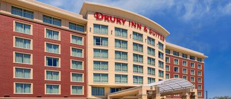 A Drury Inn & Suites hotel with a modern facade, multiple windows, and a covered entrance.