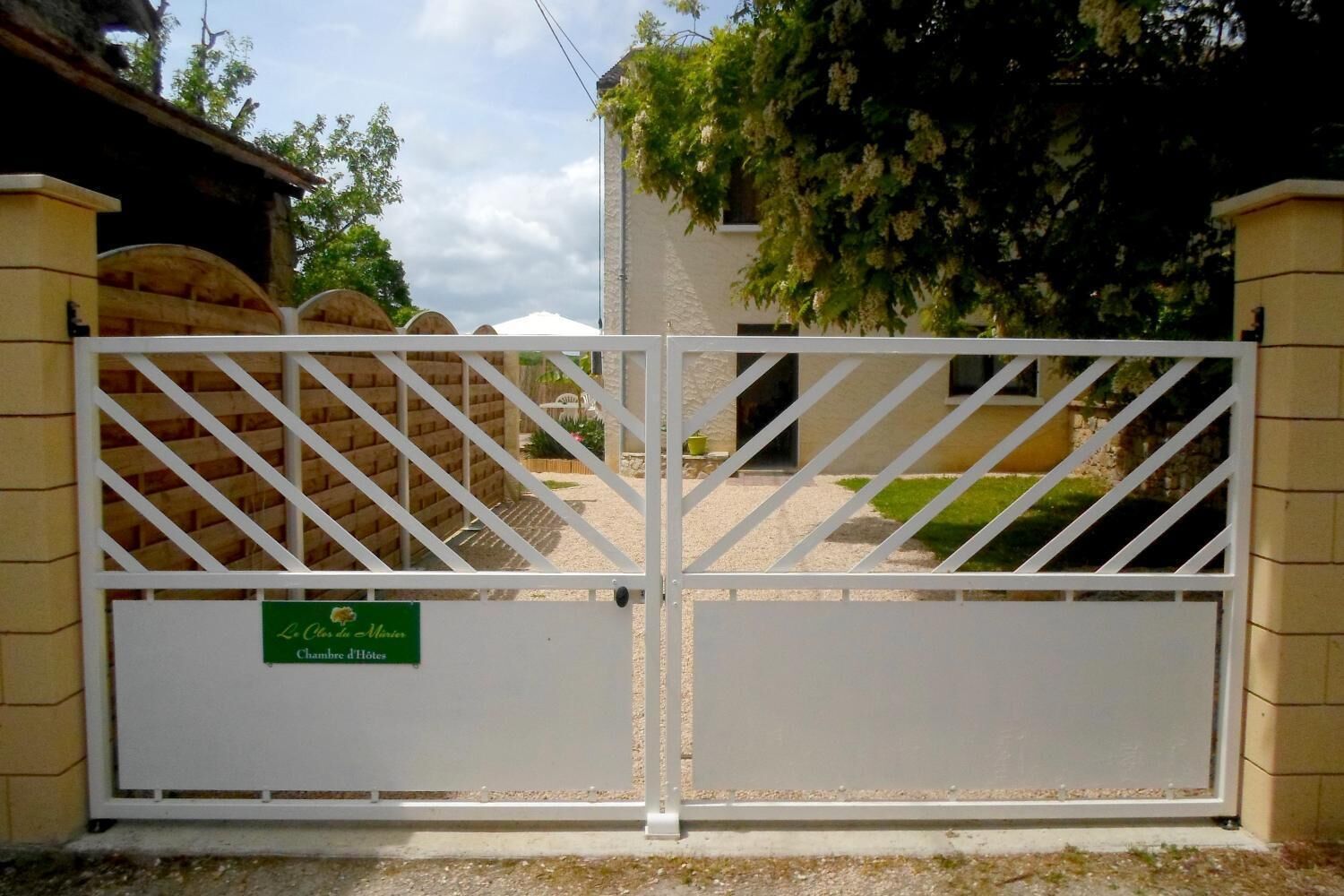 A gated entrance to a property with a sign indicating it is a hotel.