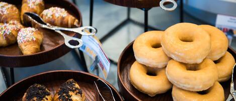 A display of pastries including croissants and donuts.