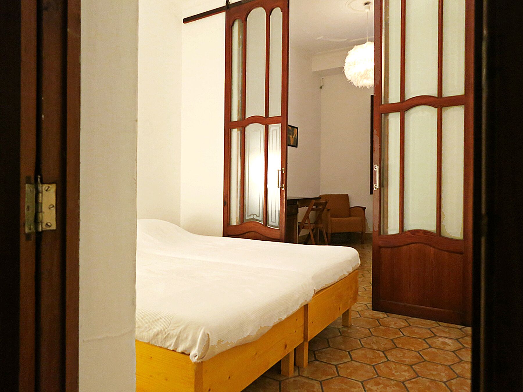 A room with a bed, a desk, and a chair.