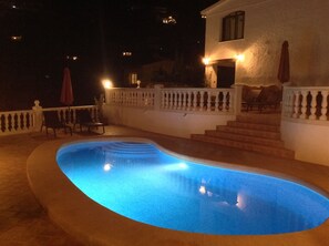A swimming pool with a curved edge, surrounded by a white balustrade and steps leading to a building. - Luxury Detach Villa, Air Con, Private Pool with sun all day, Stunning Sea Views. (Teulada)