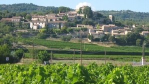 A rural village with terraced fields and traditional buildings. - Small Provence farm with pool, elegant accommodations (Joucas)