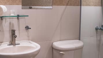 A bathroom with a sink, toilet, and shower.