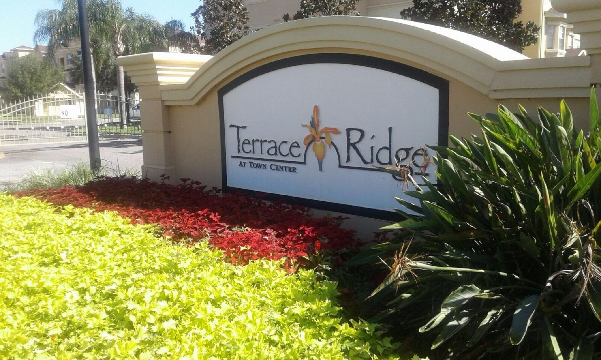 A sign for Terrace Ridge at Town Center with a landscaped area in front.