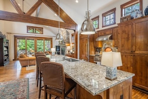 A spacious kitchen with granite countertops, wooden cabinets, and a large island. - Central Location w/ Suncadia Pool Access (Cle Elum)