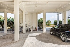 A gas station with a black SUV parked, a bicycle, and a motorcycle. - Amazing Direct Ocean Gulf Front Beach Views Condo, pool and hot tub are open! (Sanibel)