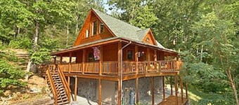 Stunning cabin nestled among the trees, featuring a loft and a relaxing hot tub.