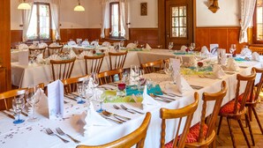A dining area with multiple tables set for a meal, each with white tablecloths, chairs, and neatly arranged cutlery. - Gasthof & Pension zum Kreuz (Lautenbach)