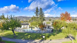 A residential area with a swimming pool, trees, and a clear sky. - 305 Northgate at Silverado in Napa - One Bedroom Condo (Napa)