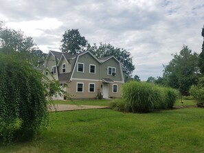 A two-story house with a front porch and a well-maintained lawn.