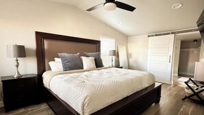 A bedroom with a bed, nightstands, a ceiling fan, and a door leading to another room. - Comfortable #Staycay Close to Everything In Dallas (Dallas)