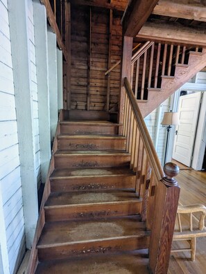 Staircase leads to an upper level with a handrail and balustrade.