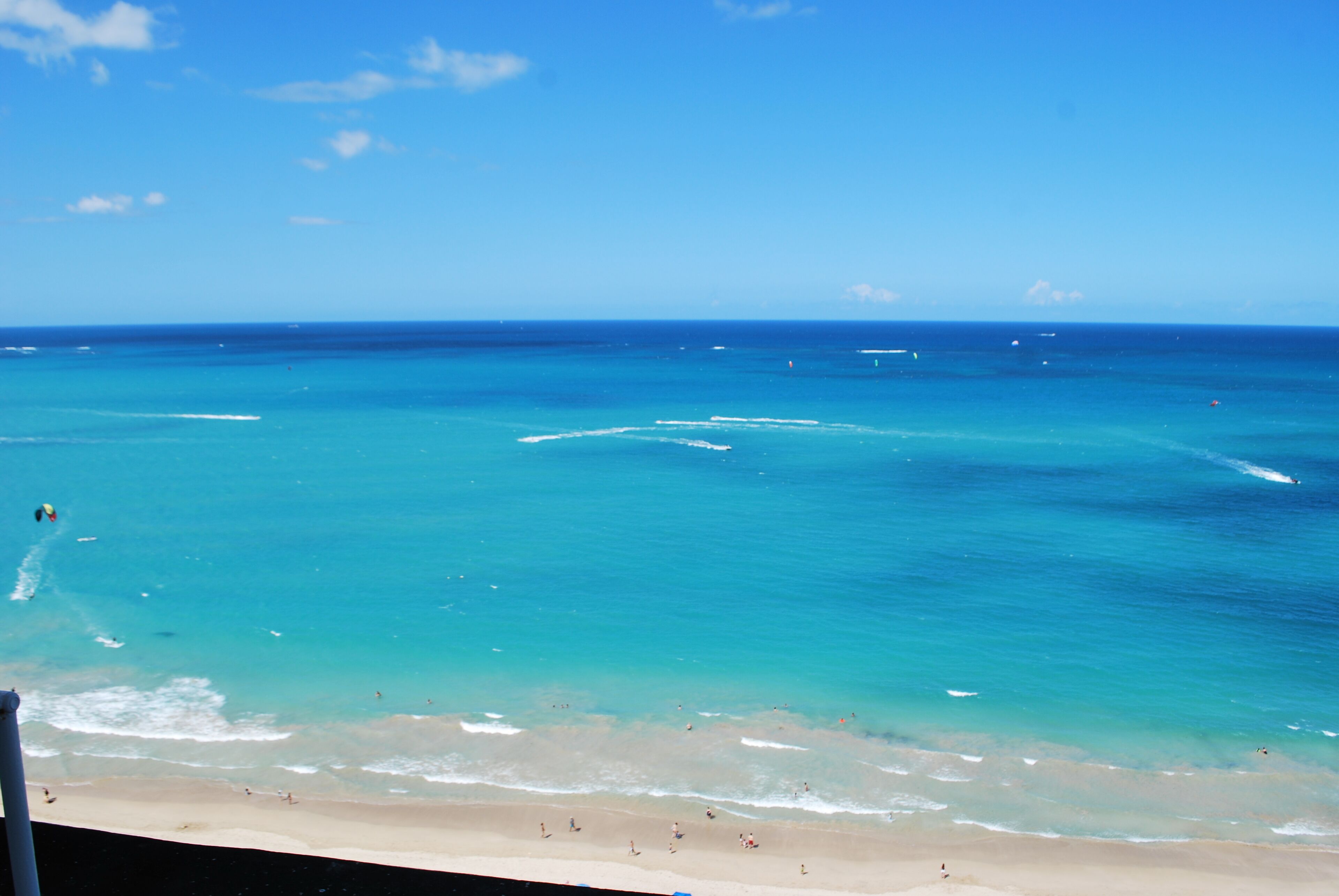 A beach with clear turquoise water and a sandy shore.