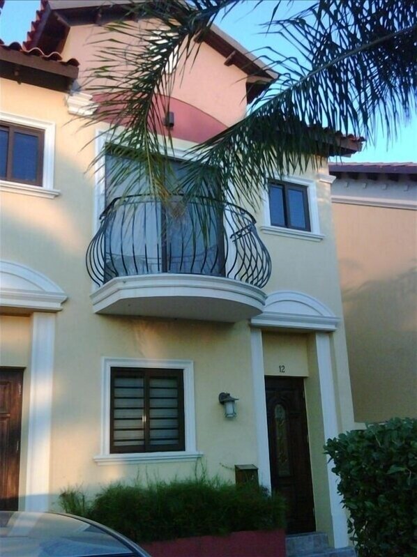 Stunning two-story residence with a central balcony and symmetrical facade.