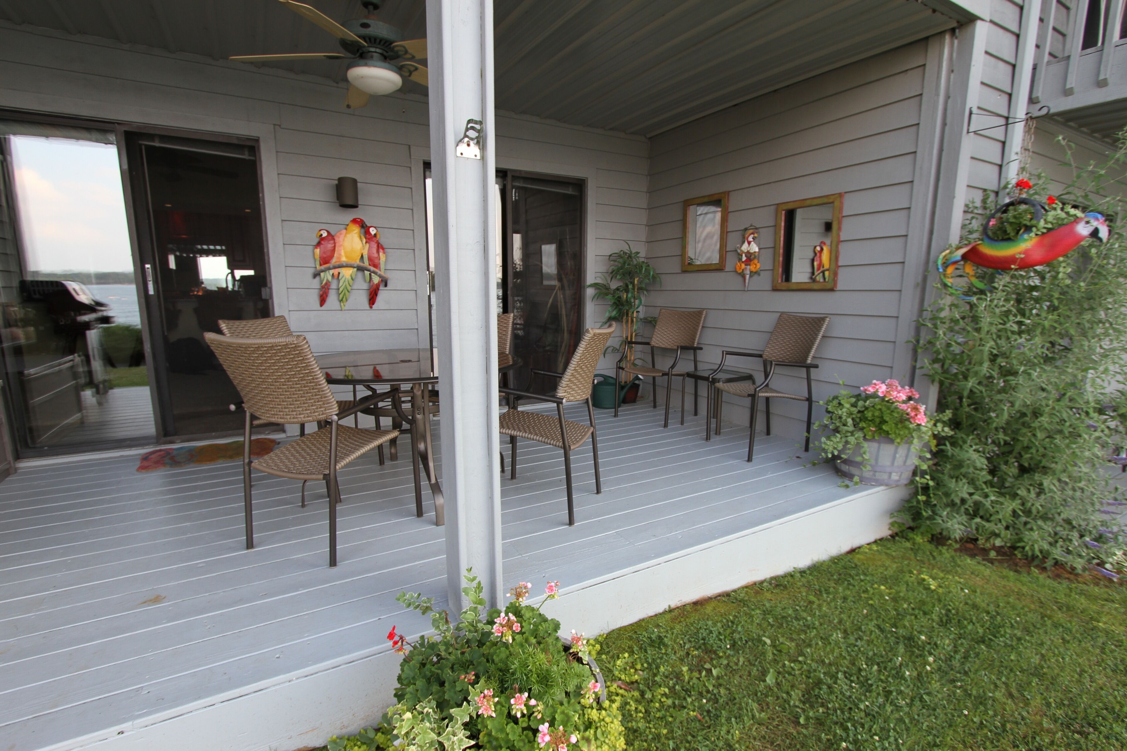 Covered porch, table w/seating for 6, flower pots during summer, and Weber grill