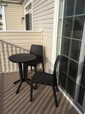 Enjoy a quiet moment on the patio with a round table and two chairs.