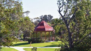 Ein Pavillon in einem Park mit einer Bank in der Nähe.