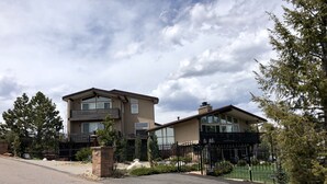 A two-story residential house with a driveway and a black metal fence. - Experience a Relaxing Retreat at Lookout Mountain Lodge (30 Day Min) (Golden)