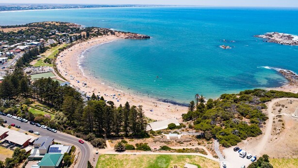 An aerial view of a coastal area with a beach, a parking lot, and a road. - Pet Friendly in Port Elliot (Port Elliot)