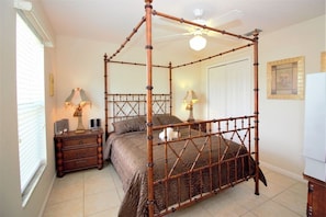 A four-poster bed with a wooden frame, a nightstand with a lamp, and a ceiling fan. - Beautiful 4 Bedroom Highlands Reserve Pool Home - 924NHD (Davenport)