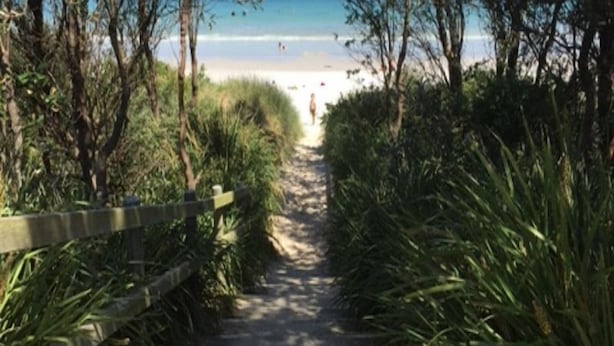 A pathway leading to a beach with a wooden fence on one side and dense vegetation on the other. - So close to the boat ramp and beach for boating enthusiasts and beach goers!!


 (Callala Bay)